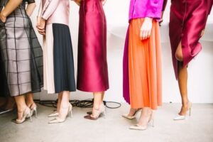 women in pink and orange dresses