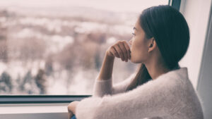 woman staring out the window