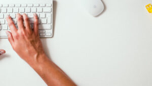 hands typing on keyboard