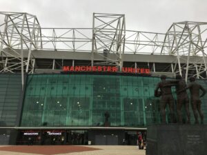 Manchester United Stadium with a statue of two men
