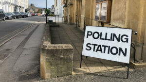 a polling station sign on the pavement
