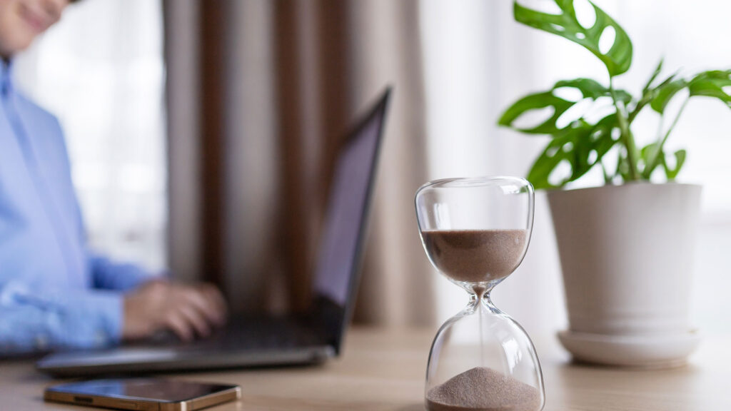 Timer and person working on laptop