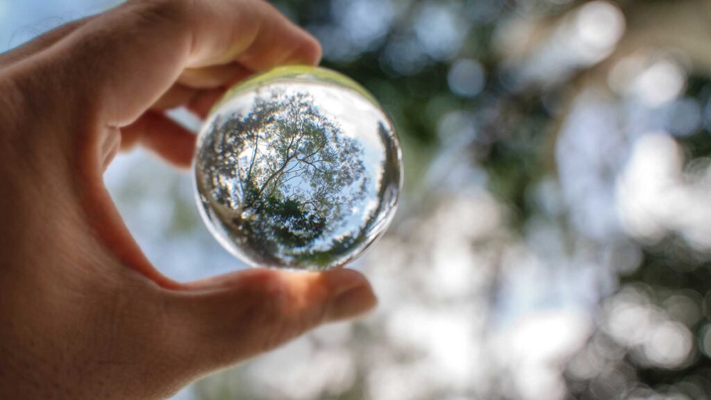 hand holding Clear glass sphere